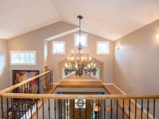This stunning entryway boasts a grand chandelier and a beautiful staircase.