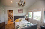 This beautiful bedroom features a cozy bed with decorative pillows and a stylish patterned throw.