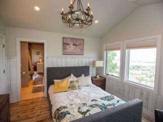 This beautiful bedroom features a cozy bed with decorative pillows and a stylish patterned throw.