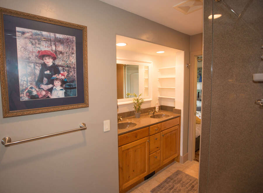 This beautiful bathroom features a stunning framed artwork, adding a touch of elegance to the space.