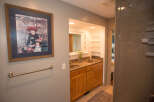 This beautiful bathroom features a stunning framed artwork, adding a touch of elegance to the space.
