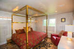 This luxurious bedroom features a stunning gold canopy bed, creating a focal point of elegance.