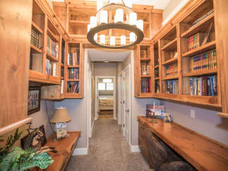 This stunning home office boasts custom built-in bookshelves, perfect for displaying your literary collection.