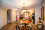 This stunning dining area features a beautiful round wooden table with elegant chairs, perfect for hosting gatherings.