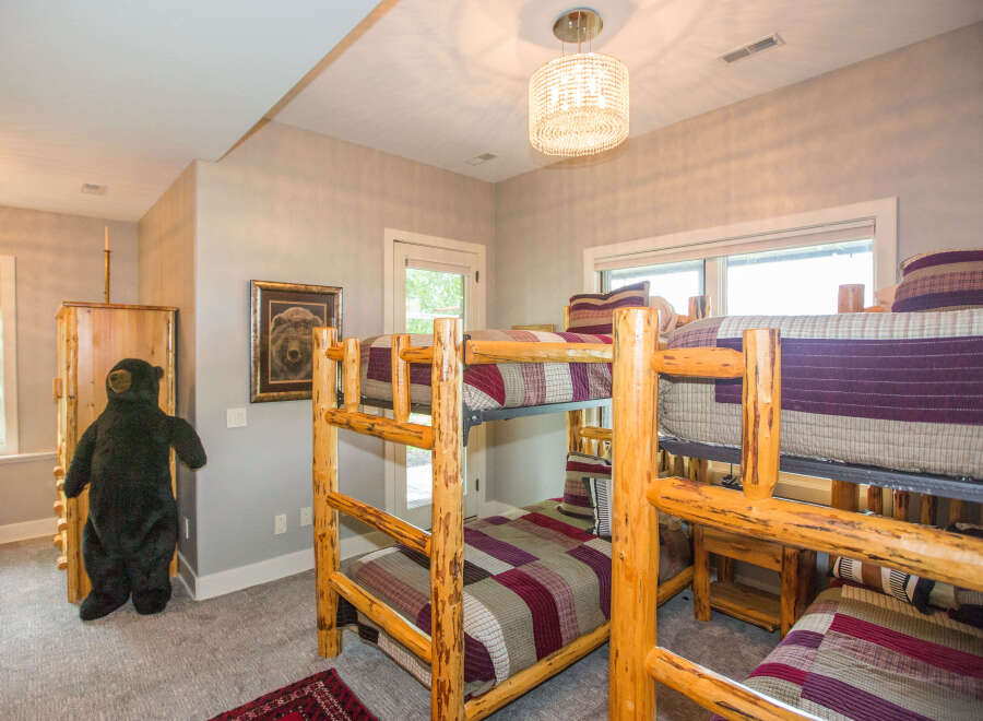 This cozy bedroom features rustic log bunk beds, perfect for a family getaway.