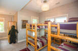 This cozy bedroom features rustic log bunk beds, perfect for a family getaway.