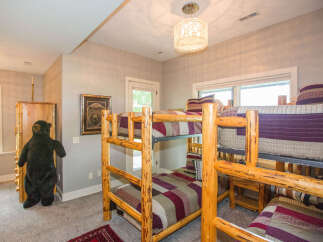 This cozy bedroom features rustic log bunk beds, perfect for a family getaway.