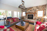 This cozy living room features a stunning stone fireplace, perfect for creating a warm and inviting atmosphere.