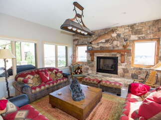 This cozy living room features a stunning stone fireplace, perfect for creating a warm and inviting atmosphere.