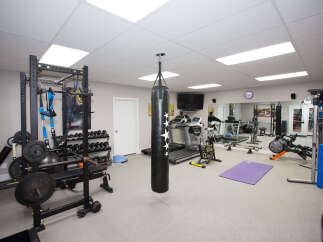 This home gym is fully equipped for a comprehensive workout.