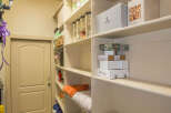 This pantry offers ample storage space with its multiple shelves, perfect for organizing food and supplies.