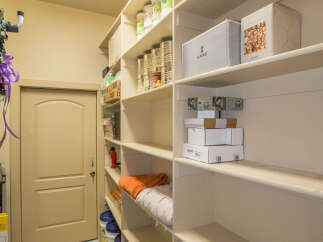 This pantry offers ample storage space with its multiple shelves, perfect for organizing food and supplies.