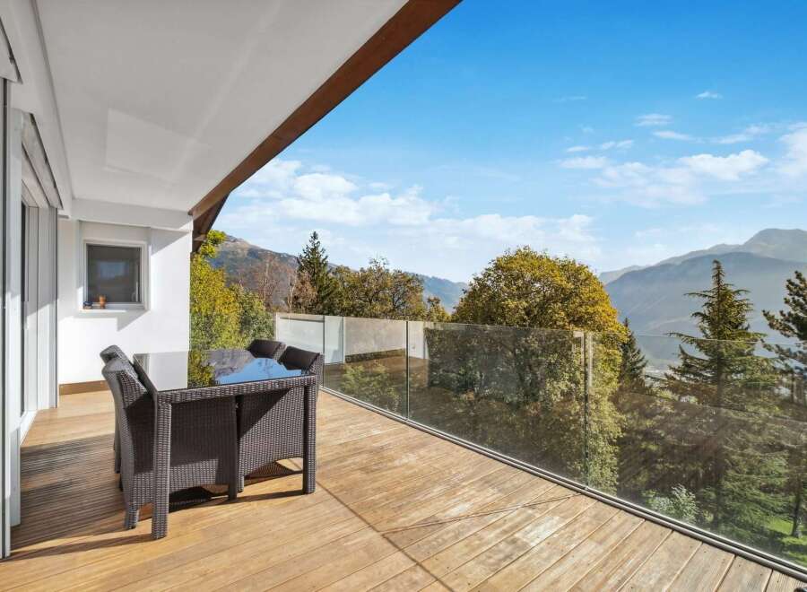 This stunning property boasts a spacious balcony with breathtaking mountain views.