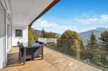 This stunning property boasts a spacious balcony with breathtaking mountain views.