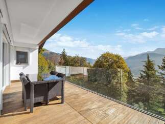 This stunning property boasts a spacious balcony with breathtaking mountain views.