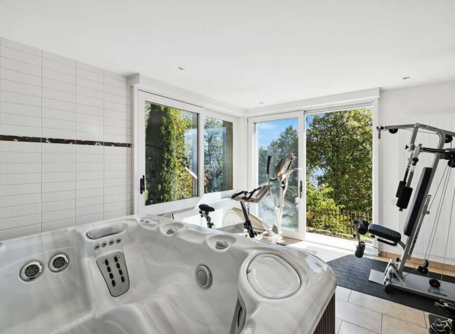 This luxurious home boasts a stunning indoor spa and home gym, perfect for relaxation and fitness.