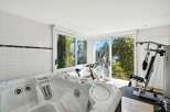 This luxurious home boasts a stunning indoor spa and home gym, perfect for relaxation and fitness.