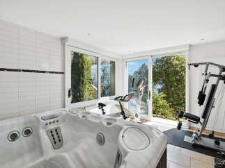 This luxurious home boasts a stunning indoor spa and home gym, perfect for relaxation and fitness.
