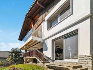 This stunning property boasts a modern design with a spacious balcony offering breathtaking views.