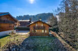 Discover a charming wooden chalet nestled in a picturesque mountain setting.