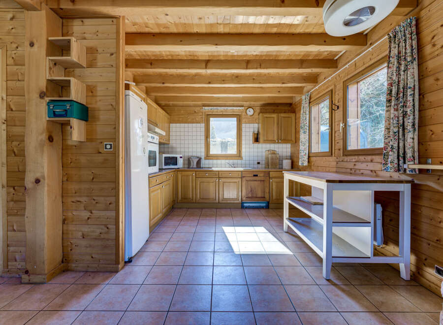 Step into this charming kitchen, featuring warm wooden accents and a cozy atmosphere.