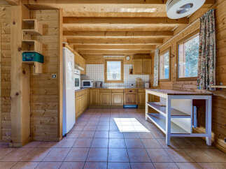 Step into this charming kitchen, featuring warm wooden accents and a cozy atmosphere.