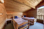 Cozy up in this charming bedroom with its warm wooden accents and inviting atmosphere.