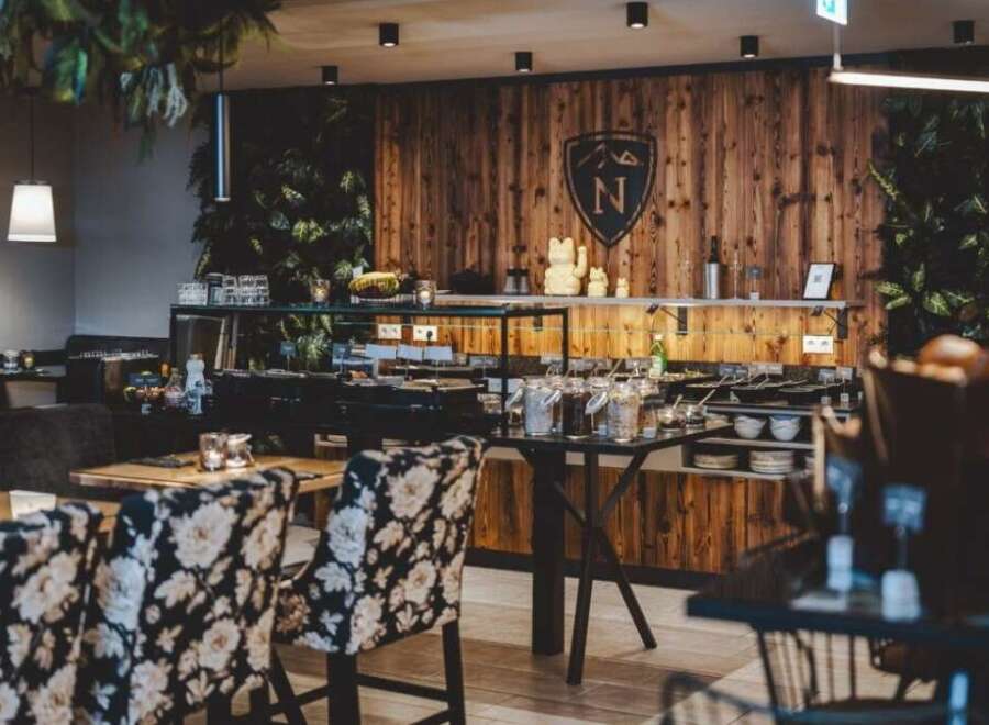 Step into a beautifully designed restaurant with a warm and inviting atmosphere.