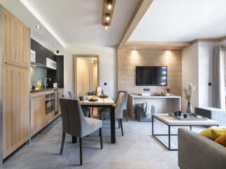 This stunning apartment boasts an open-plan living area with a modern kitchen, dining table, and comfortable seating.