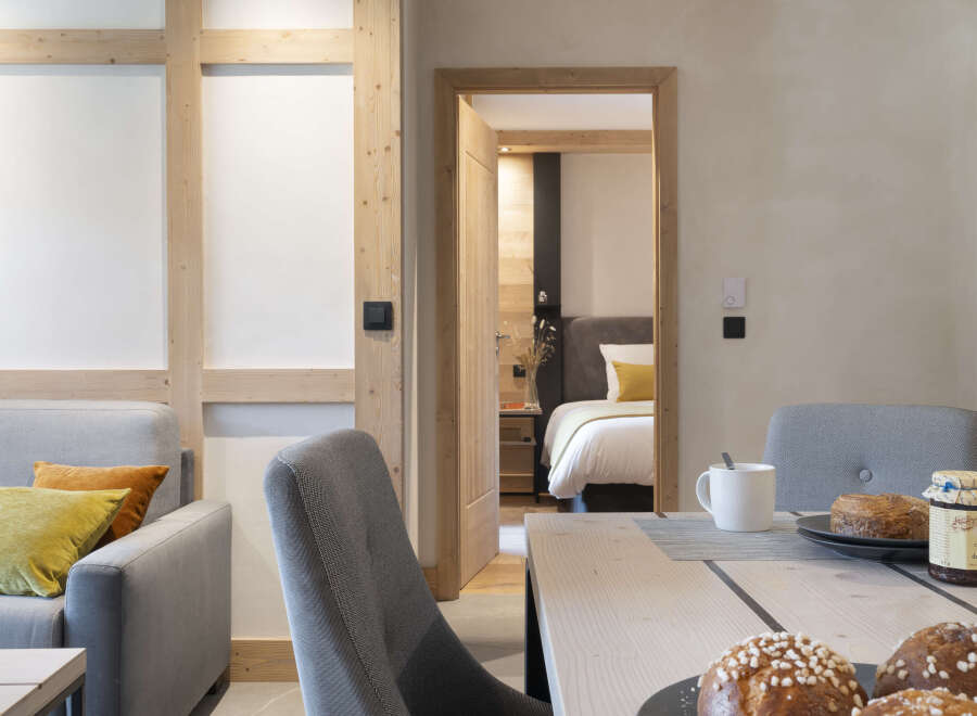 This stunning apartment boasts a spacious open-plan living area with a modern kitchen and dining space, perfect for entertaining guests.