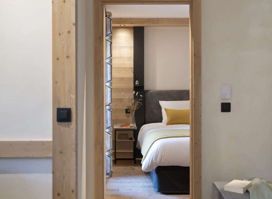 This stunning bedroom features a cozy and inviting atmosphere with its light wood accents and neutral color palette.