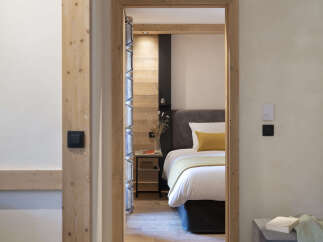 This stunning bedroom features a cozy and inviting atmosphere with its light wood accents and neutral color palette.