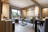 This stunning apartment boasts a spacious open-plan living area with floor-to-ceiling windows offering breathtaking views of the surrounding forest.