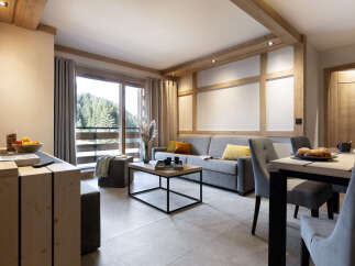 This stunning apartment boasts a spacious open-plan living area with floor-to-ceiling windows offering breathtaking views of the surrounding forest.