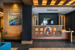 This hotel boasts a stunning reception area with a unique copper and wood design, featuring a backlit bear logo.