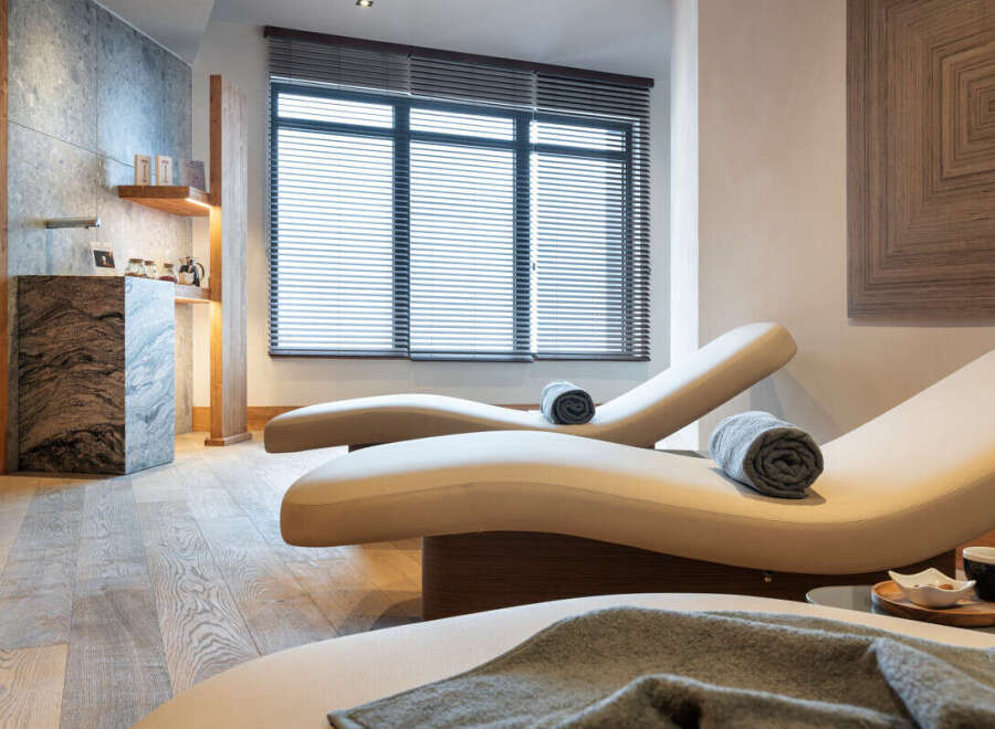 Relax and rejuvenate in our luxurious spa, featuring comfortable chaise lounges perfect for unwinding.