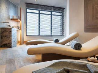 Relax and rejuvenate in our luxurious spa, featuring comfortable chaise lounges perfect for unwinding.