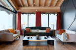 Luxurious chalet living room with floor-to-ceiling windows offering breathtaking mountain views.