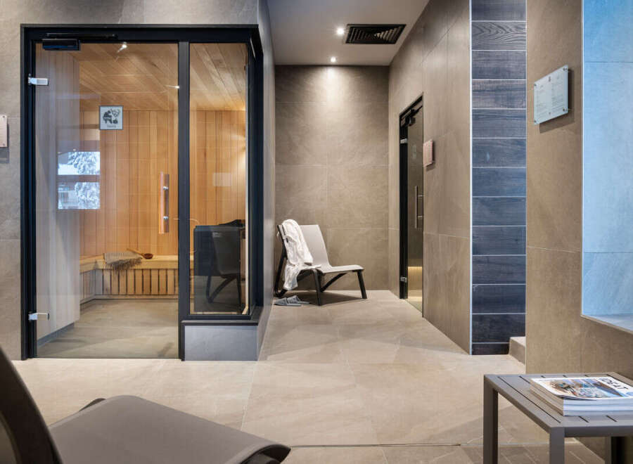 Relax and rejuvenate in our luxurious spa featuring a modern sauna with glass doors, providing a tranquil escape.