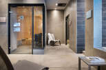 Relax and rejuvenate in our luxurious spa featuring a modern sauna with glass doors, providing a tranquil escape.