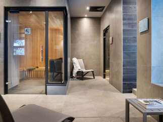 Relax and rejuvenate in our luxurious spa featuring a modern sauna with glass doors, providing a tranquil escape.