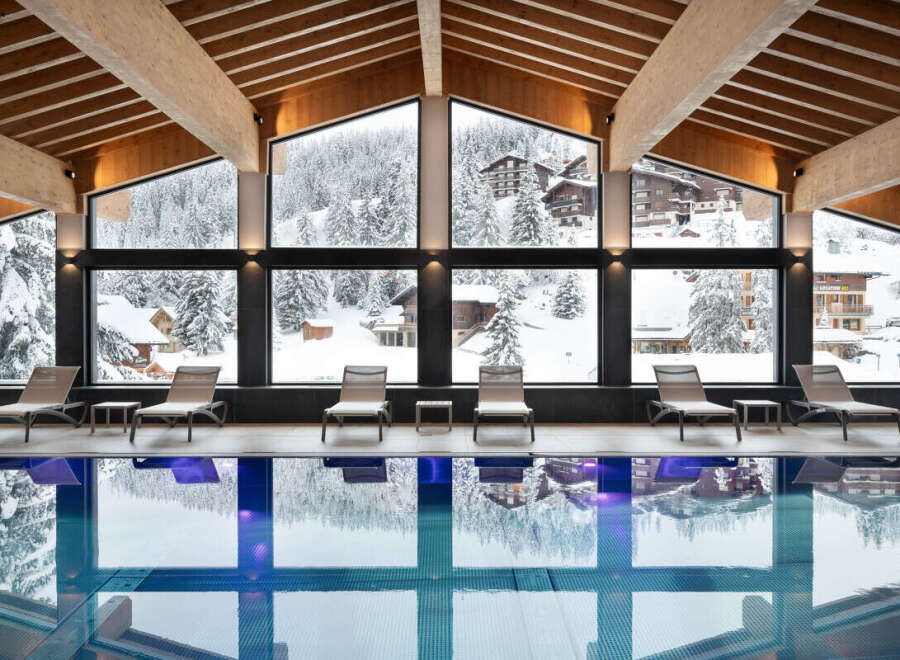 Indulge in a luxurious indoor pool experience at our stunning resort, surrounded by breathtaking views of snow-capped mountains and charming alpine villages.