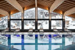 Indulge in a luxurious indoor pool experience at our stunning resort, surrounded by breathtaking views of snow-capped mountains and charming alpine villages.