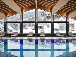Indulge in a luxurious indoor pool experience at our stunning resort, surrounded by breathtaking views of snow-capped mountains and charming alpine villages.