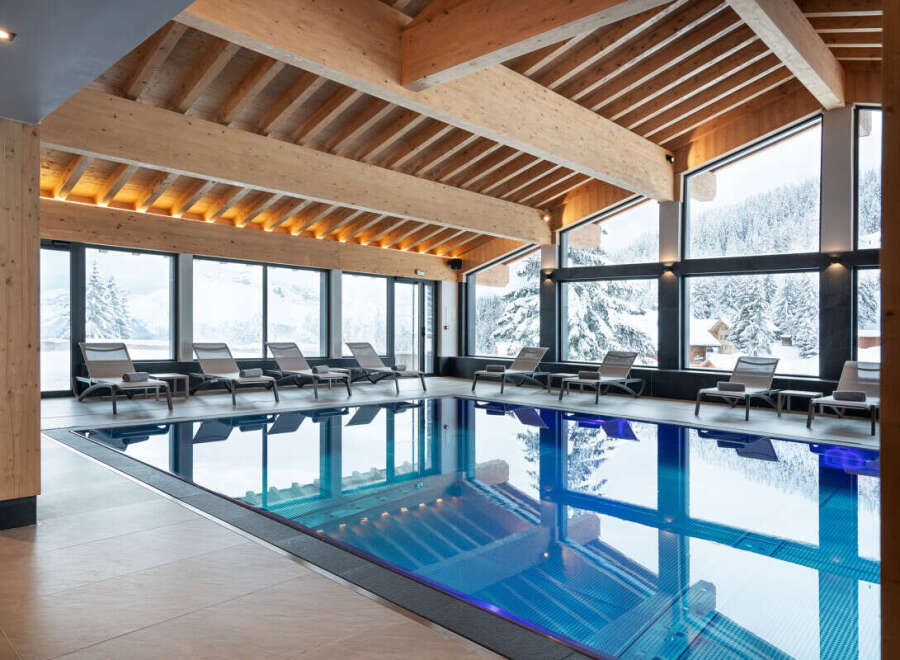 Indulge in the serene atmosphere of our indoor pool, surrounded by floor-to-ceiling windows offering breathtaking views of the snow-capped mountains.