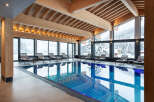 Indulge in the serene atmosphere of our indoor pool, surrounded by floor-to-ceiling windows offering breathtaking views of the snow-capped mountains.
