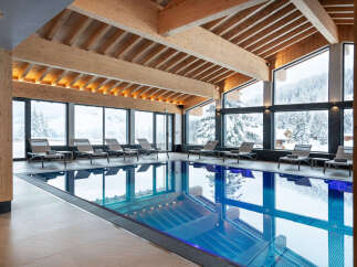 Indulge in the serene atmosphere of our indoor pool, surrounded by floor-to-ceiling windows offering breathtaking views of the snow-capped mountains.