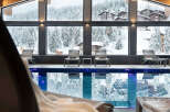 Indulge in the ultimate relaxation experience at our luxurious hotel, featuring a stunning indoor pool with floor-to-ceiling windows offering breathtaking views of the snow-capped mountains.