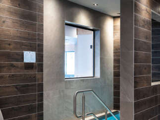 Relax and rejuvenate in our luxurious spa, featuring a tranquil plunge pool surrounded by sleek, modern tiling.