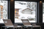 Luxury hotel pool with stunning views of a snow-covered mountain landscape.